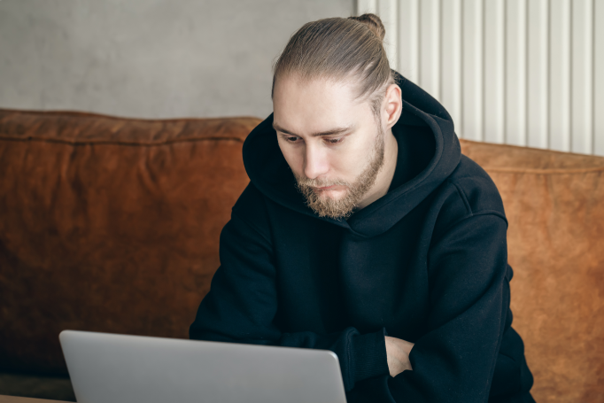 Man with beard on laptop